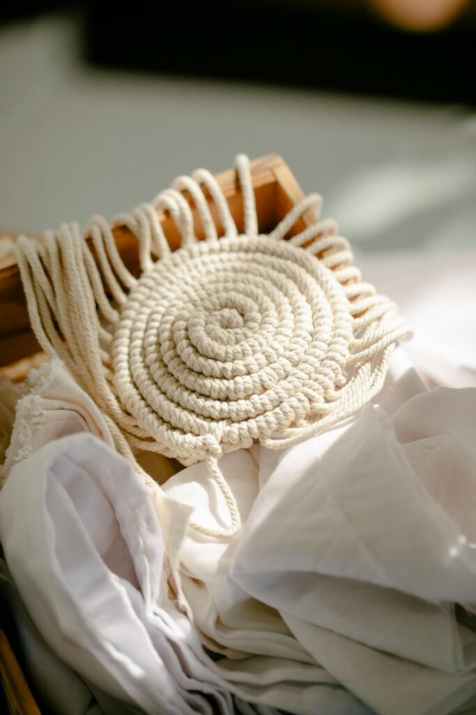 pexels photo 6850579 6850579 A detailed close-up of a handcrafted macrame piece in soft natural light, showcasing intricate weaving patterns.