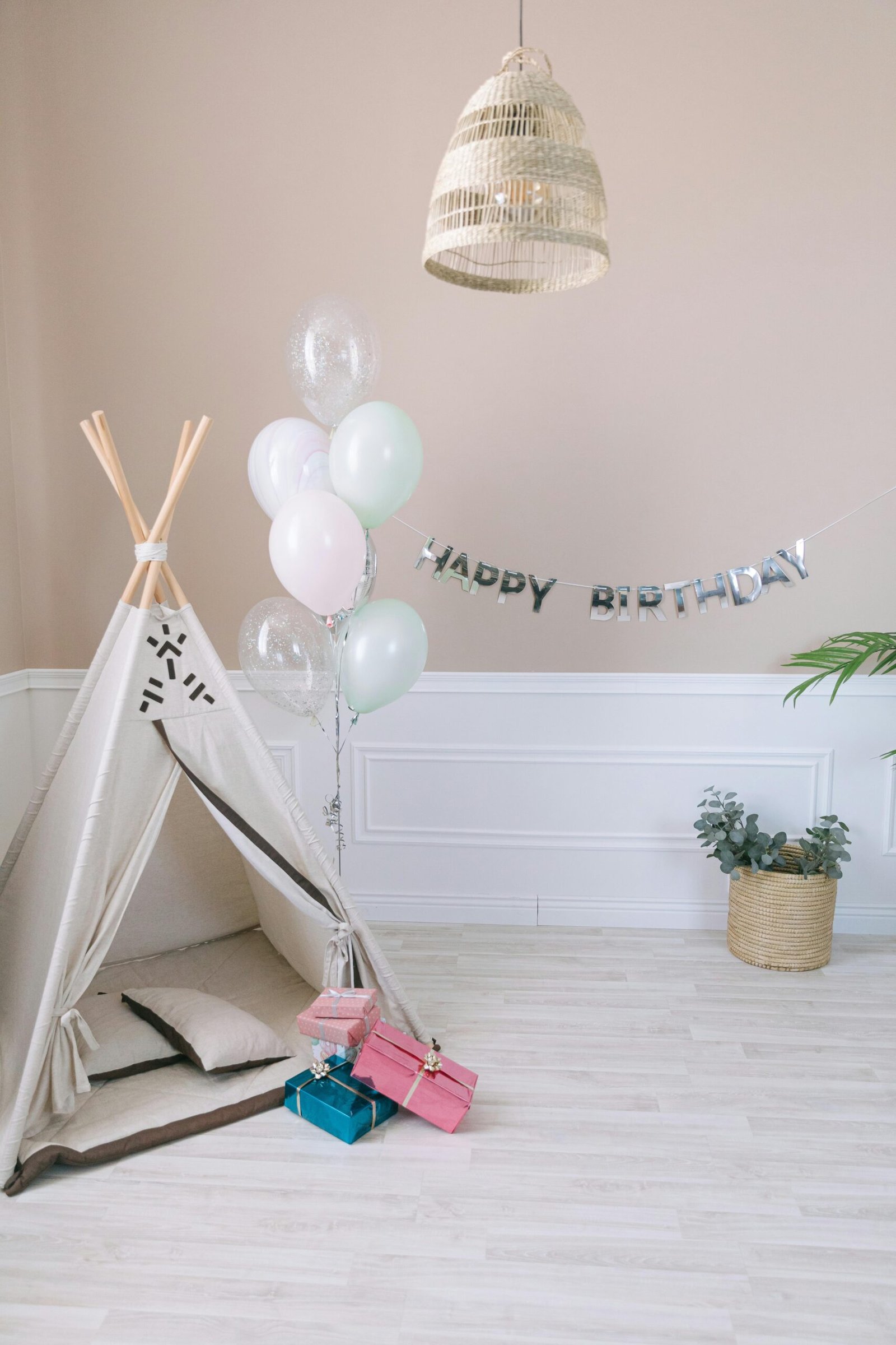 pexels photo 7599531 7599531 Cozy indoor birthday setup with teepee, balloons, and presents, perfect for kids' celebrations.